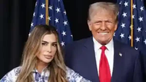 Siggy Flicker poses with Donald Trump in front of American flags